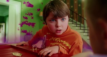 Movie still from “The Cat in the Hat” (2003), directed by Bo Welch – A young boy is sitting at a table with a pen in his hand; Close Up shot, High angle