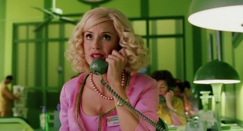 Movie still from “The Cat in the Hat” (2003), directed by Bo Welch – A woman talking on a phone while wearing a pink dress; Medium shot, Low angle