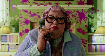 Movie still from “The Cat in the Hat” (2003), directed by Bo Welch – An older woman talking on a phone while wearing a pink wig; Close Up shot, High angle