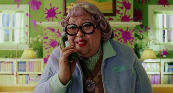 Movie still from “The Cat in the Hat” (2003), directed by Bo Welch – An older woman talking on a phone while wearing glasses; Medium shot, High angle