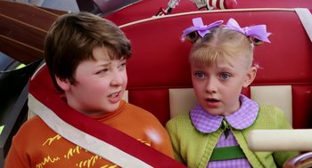 Movie still from “The Cat in the Hat” (2003), directed by Bo Welch – Two young children sitting on a seat in a car; Close Up shot, High angle