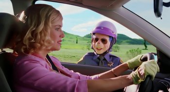 Movie still from “The Cat in the Hat” (2003), directed by Bo Welch – A woman in a pink shirt and a woman in a purple shirt in a car; Medium shot, Over the shoulder angle