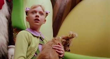Movie still from “The Cat in the Hat” (2003), directed by Bo Welch – A young girl holding a small dog in her arms; Close Up shot, Low angle