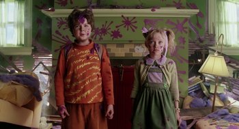 Movie still from “The Cat in the Hat” (2003), directed by Bo Welch – Two children standing next to each other in front of a fireplace; Medium shot, High angle