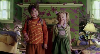 Movie still from “The Cat in the Hat” (2003), directed by Bo Welch – Two children are standing in front of a fireplace; Medium shot, Overhead angle