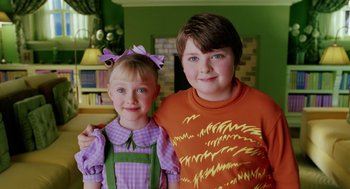 Movie still from “The Cat in the Hat” (2003), directed by Bo Welch – Two children pose for a picture in a green room; Close Up shot, High angle
