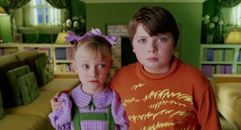 Movie still from “The Cat in the Hat” (2003), directed by Bo Welch – A boy and a little girl posing for a picture; Close Up shot, High angle