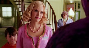 Movie still from “The Cat in the Hat” (2003), directed by Bo Welch – A woman in a pink dress and a pink necklace; Close Up shot, Over the shoulder angle