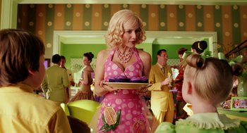 Movie still from “The Cat in the Hat” (2003), directed by Bo Welch – A woman holding a tray of food in front of a group of people; Medium shot, Over the shoulder angle