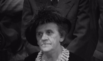 Movie still from “The Cremator” (1969), directed by Juraj Herz – An older woman wearing a hat and a suit; Close Up shot, High angle