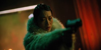 Movie still from “Altered Carbon” (2018), created by Laeta Kalogridis – A woman in a green coat holding a gun; Close Up shot, Low angle