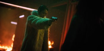 Movie still from “Altered Carbon” (2018), created by Laeta Kalogridis – A man in a fur coat is holding a gun; Medium shot, Low angle