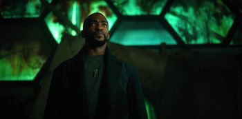Movie still from “Altered Carbon” (2018), created by Laeta Kalogridis – A man standing in front of a green light; Close Up shot, Low angle