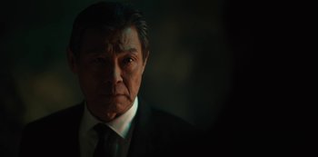 Movie still from “Altered Carbon” (2018), created by Laeta Kalogridis – A person wearing a suit and tie; Close Up shot, Low angle