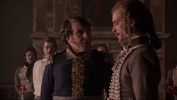 Movie still from “The Duellists” (1977), directed by Ridley Scott – Two men in military garb talking to each other; Medium shot, Over the shoulder angle