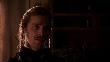 Movie still from “The Duellists” (1977), directed by Ridley Scott – A person wearing a suit and tie; Close Up shot, Over the shoulder angle