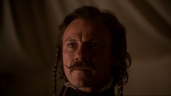 Movie still from “The Duellists” (1977), directed by Ridley Scott – A person with long hair and a mustache; Close Up shot, Low angle