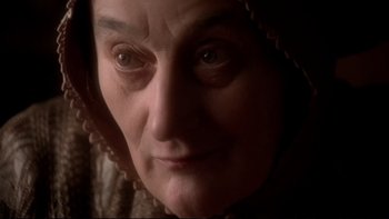 Movie still from “The Duellists” (1977), directed by Ridley Scott – An older woman with a hood over her head; Close Up shot, High angle