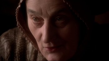 Movie still from “The Duellists” (1977), directed by Ridley Scott – An older woman with a hood over her head; Close Up shot, Over the shoulder angle