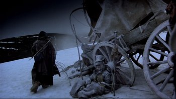 Movie still from “The Duellists” (1977), directed by Ridley Scott – A man sitting on the ground next to a wagon; Wide shot, High angle