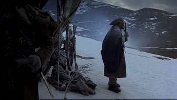 Movie still from “The Duellists” (1977), directed by Ridley Scott – A man standing on top of a snow covered slope; Wide shot, Low angle