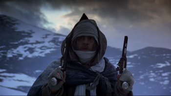 Movie still from “The Duellists” (1977), directed by Ridley Scott – A man holding two guns in his hands; Medium shot, Low angle