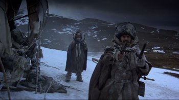 Movie still from “The Duellists” (1977), directed by Ridley Scott – Two men in winter clothing standing on a snowy hill; Medium shot, Low angle