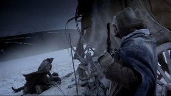 Movie still from “The Duellists” (1977), directed by Ridley Scott – A man in a hooded jacket is holding a rifle; Medium shot, Low angle