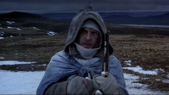 Movie still from “The Duellists” (1977), directed by Ridley Scott – A man in a hooded jacket holding a gun; Medium shot, Low angle