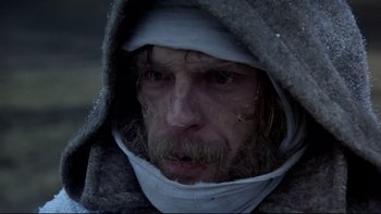 Movie still from “The Duellists” (1977), directed by Ridley Scott – A person with a beard wearing a hood; Close Up shot, Low angle