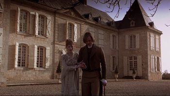 Movie still from “The Duellists” (1977), directed by Ridley Scott – A man and a woman standing in front of a building; Wide shot, Low angle
