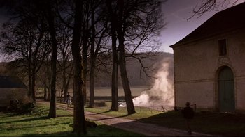 Movie still from “The Duellists” (1977), directed by Ridley Scott – Smoke billows out of a fire in a wooded area; Extreme Wide shot, High angle