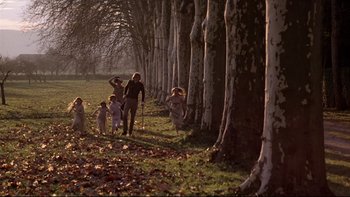 Movie still from “The Duellists” (1977), directed by Ridley Scott – A group of people walking in a park near a forest; Wide shot, High angle