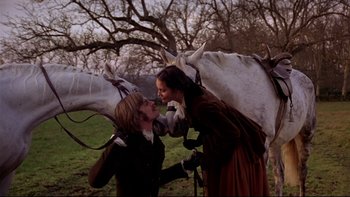 Movie still from “The Duellists” (1977), directed by Ridley Scott – A man and a woman kissing in front of a horse; Medium shot, Low angle