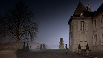 Movie still from “The Duellists” (1977), directed by Ridley Scott – A person standing in front of a building at night; Extreme Wide shot, Low angle
