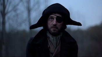 Movie still from “The Duellists” (1977), directed by Ridley Scott – A man wearing a pirate's hat and eye patch; Close Up shot, Low angle