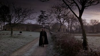 Movie still from “The Duellists” (1977), directed by Ridley Scott – A person walking down a path in the middle of the night; Extreme Wide shot, Low angle