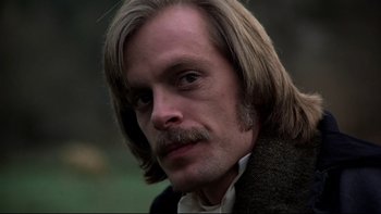 Movie still from “The Duellists” (1977), directed by Ridley Scott – A person with long hair and a mustache; Close Up shot, Low angle