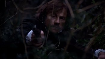 Movie still from “The Duellists” (1977), directed by Ridley Scott – A man with a gun in the woods at night; Close Up shot, Low angle