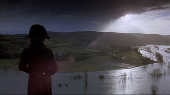 Movie still from “The Duellists” (1977), directed by Ridley Scott – A man standing on a hill looking at a lake; Extreme Wide shot, High angle