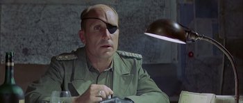Movie still from “The Eagle Has Landed” (1976), directed by John Sturges – A man in a military uniform and eye patch; Close Up shot, Over the shoulder angle