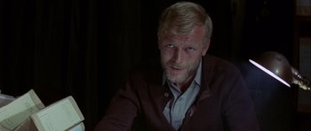 Movie still from “The Eagle Has Landed” (1976), directed by John Sturges – A person sitting in a chair; Close Up shot, Over the shoulder angle