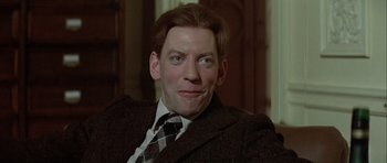 Movie still from “The Eagle Has Landed” (1976), directed by John Sturges – A person wearing a suit and tie; Close Up shot, Low angle