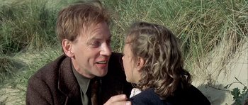 Movie still from “The Eagle Has Landed” (1976), directed by John Sturges – A man and a woman are talking in a field; Close Up shot, Over the shoulder angle