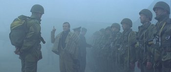 Movie still from “The Eagle Has Landed” (1976), directed by John Sturges – A group of men standing next to each other in the fog; Medium shot, Low angle