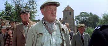Movie still from “The Eagle Has Landed” (1976), directed by John Sturges – An older man wearing a hat and a sweater; Close Up shot, Low angle