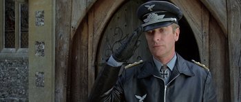 Movie still from “The Eagle Has Landed” (1976), directed by John Sturges – A man in a german military uniform saluting; Close Up shot, Low angle