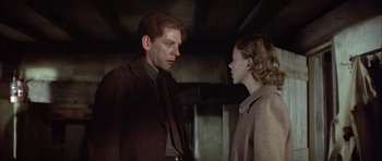 Movie still from “The Eagle Has Landed” (1976), directed by John Sturges – A man and a woman standing next to each other; Close Up shot, Low angle