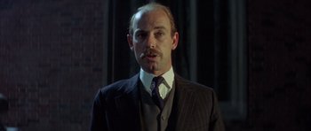 Movie still from “The Eagle Has Landed” (1976), directed by John Sturges – A person wearing a suit and a tie; Close Up shot, Low angle