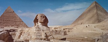 Movie still from “The Egyptian” (1954), directed by Michael Curtiz – A large sphinx statue in the middle of the desert; Extreme Wide shot, Low angle